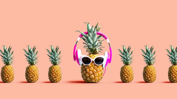 One out unique pineapple wearing headphones