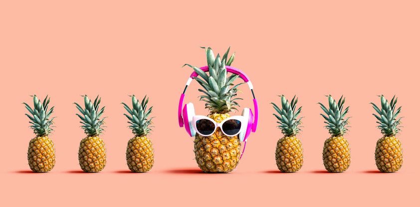 One out unique pineapple wearing headphones