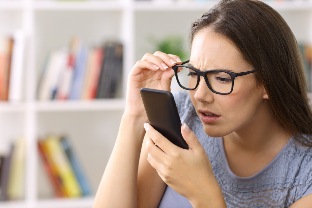 Girl,Wearing,Eyeglasses,With,Eyesight,Problems,Trying,To,Read,Phone