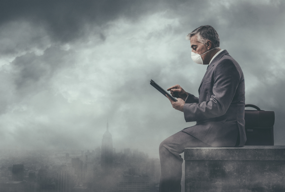 Businessman,Sitting,On,A,Rooftop,In,A,Polluted,City,And