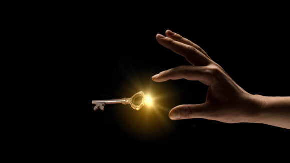 Close,Up,Image,Of,Business,Person,Holding,Shining,Key