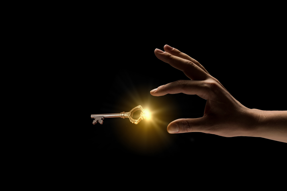 Close,Up,Image,Of,Business,Person,Holding,Shining,Key
