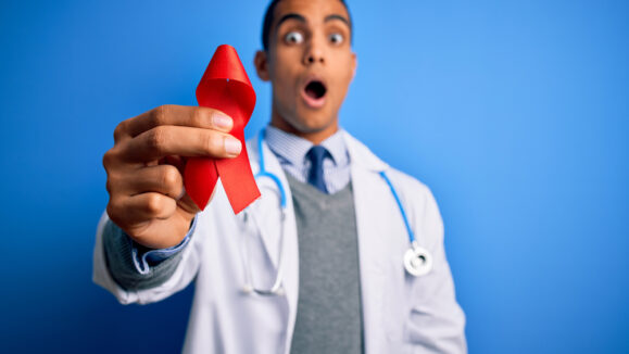 Young,Handsome,African,American,Doctor,Man,Holding,Red,Hiv,Ribbon