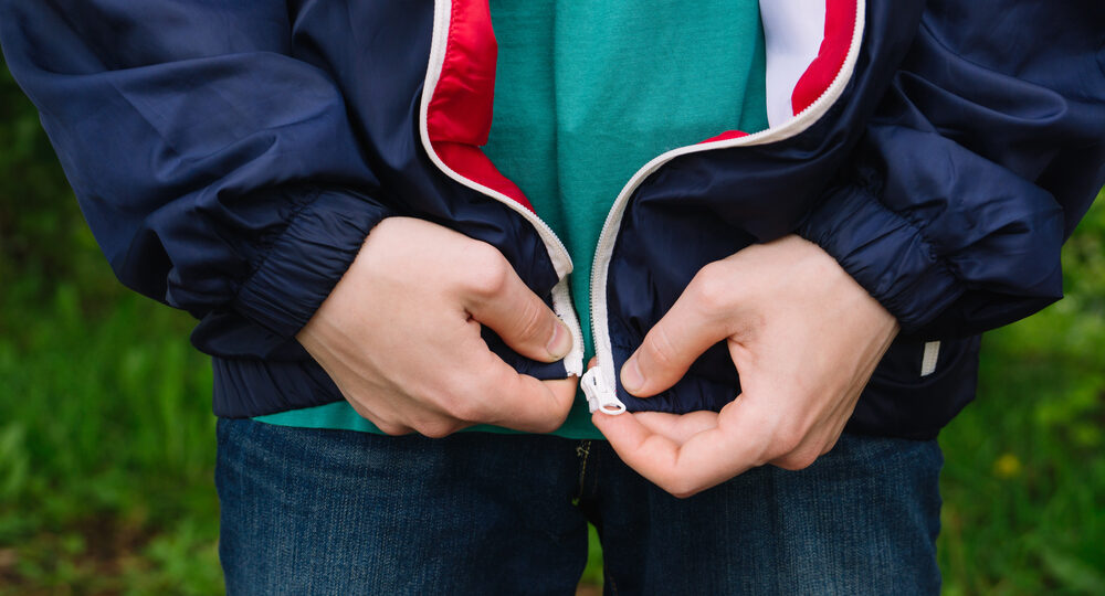 A,Man,Zips,Up,A,Jacket.,Hands,Closeup.,Natural.,It's