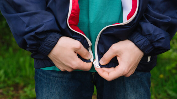 A,Man,Zips,Up,A,Jacket.,Hands,Closeup.,Natural.,It's