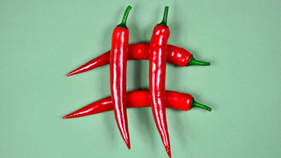 Hashtag.,Red,Hot,Chili,Pepper,On,A,Green,Background.