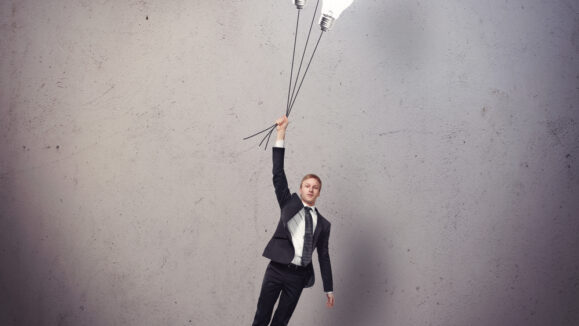 Businessman,Flying,With,Light,Bulbs