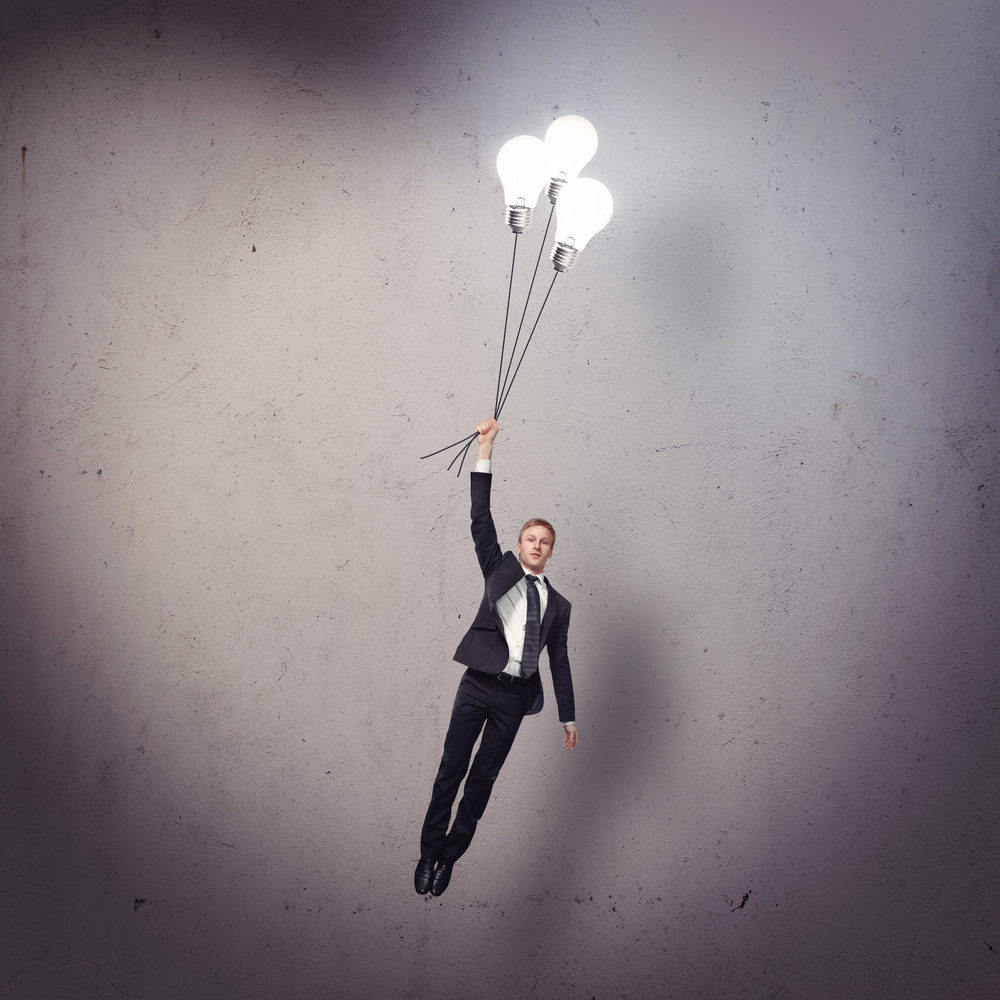 Businessman,Flying,With,Light,Bulbs