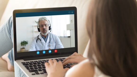 Pc,Monitor,View,Over,Girl,Shoulder,,Old,Doctor,Wear,Uniform