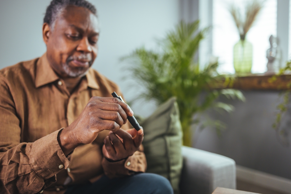 Senior,African,Man,Hands,Using,Lancet,On,Finger,To,Check